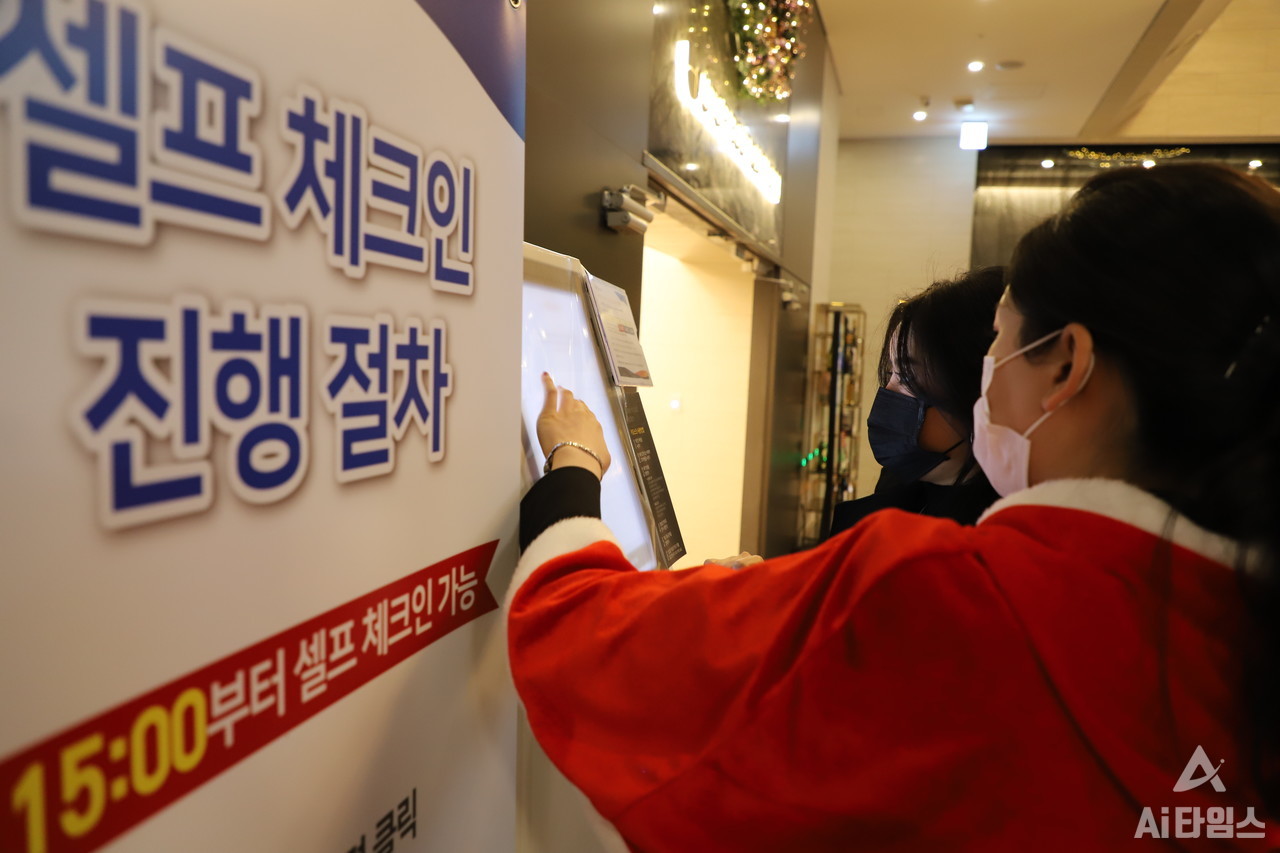 21일 방문한 광주광역시 서구의 한 복합스마트호텔에서 한 고객이 직원의 도움을 받아 키오스크 셀프체크인을 하고 있다. 이 호텔의 경우 체크인 시스템에 데스크 체크인, 키오스크를 통한 객실 키 발급, 모바일을 통한 비대면 체크인, 편의점 내 키오스크 통한 체크인 등 총 4가지 방법을 도입해 비대면 서비스를 강화했다. 