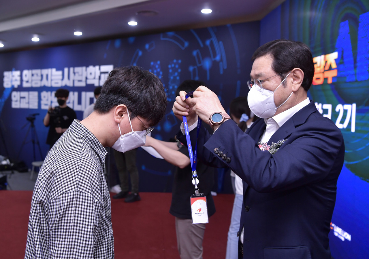 이용섭 광주광역시장이 15일 오후 광주과학기술진흥원에서 '인공지능사관학교 2기 교육생 입교식'에 참석해 교육생들에게 생도증을 목에 걸어주고 있다. (사진=광주시 제공).