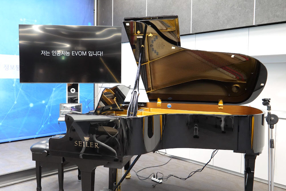 인공지능(AI) 음악 스타트업 크리에이티브마인드가 2021년 광주디자인비엔날레 AI관에서 선보인 작품 ‘Peace of Mind’. 관람객이 현장에서 AI 작곡 도움 서비스 '뮤지아(MUSIA)를 통해 AI작곡가 ‘이봄(EvoM)’과 함께 작곡하면, 완성한 곡을 자동피아노가 즉석으로 연주해주는 방식으로 운영된다. (사진=광주광역시 제공).