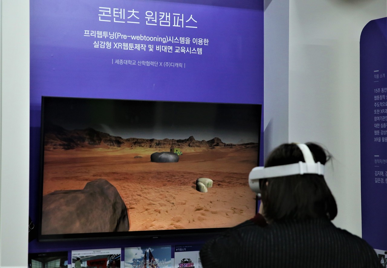 2021 콘텐츠 인재양성사업 통합 성과발표회에서 '콘텐츠 원캠퍼스 구축운영 사업’ 성과가 전시돼 참가자가 체험하고 있는 모습. (사진=한국콘텐츠진흥원 제공).