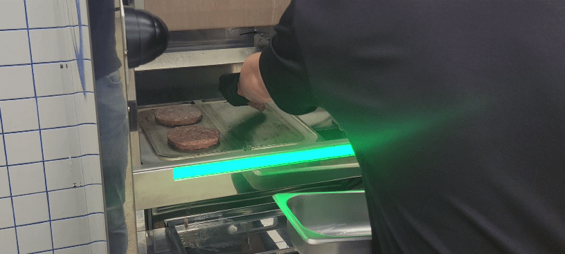 The patties are placed inside the Alpha Grill.